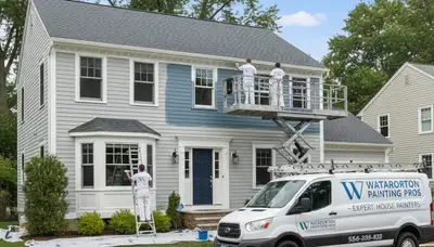 Professional house painters working on exterior home in Burlington MA